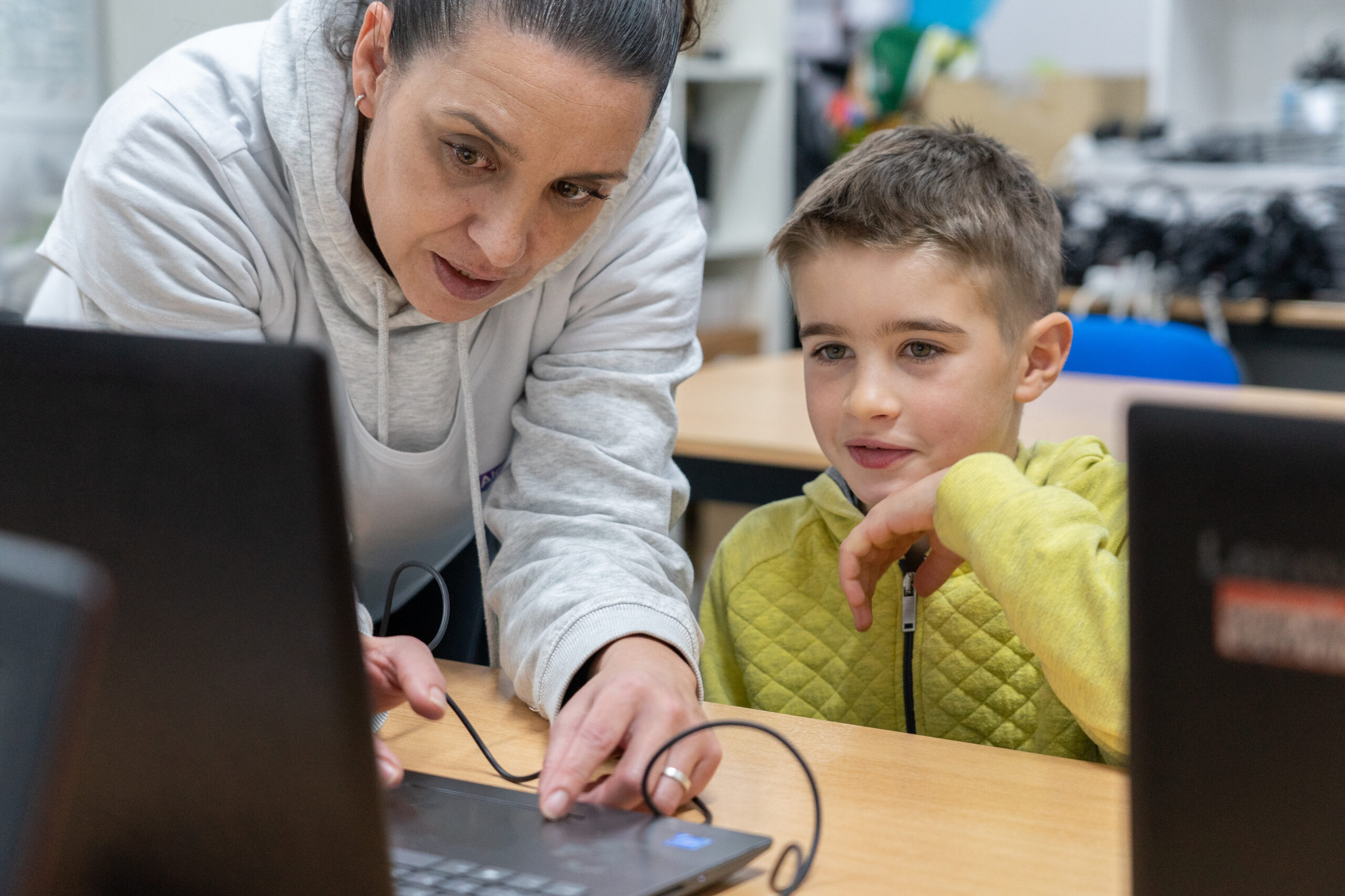 teacher teaching programming to a child
